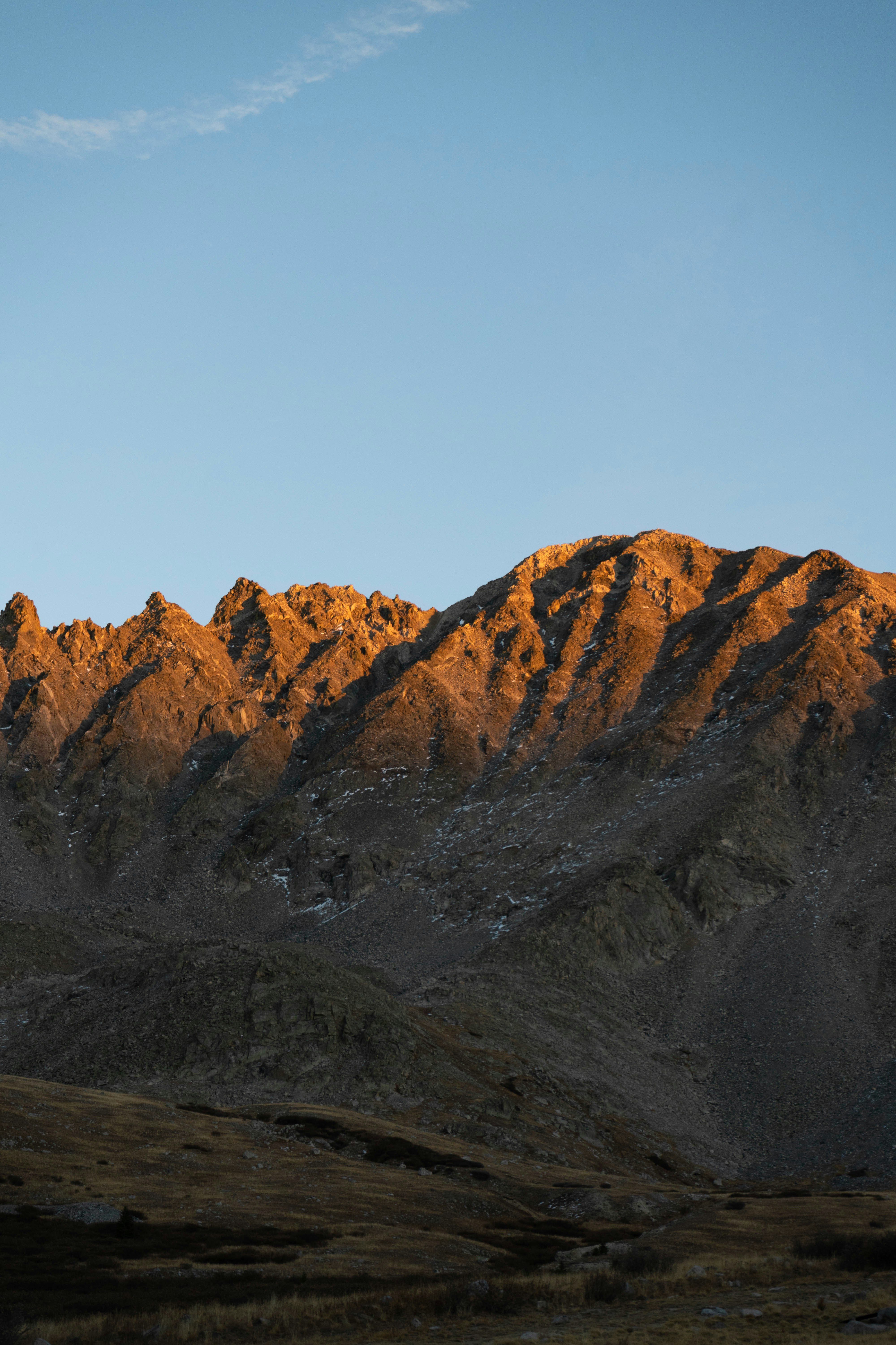 brown rocky mountain under gray sky